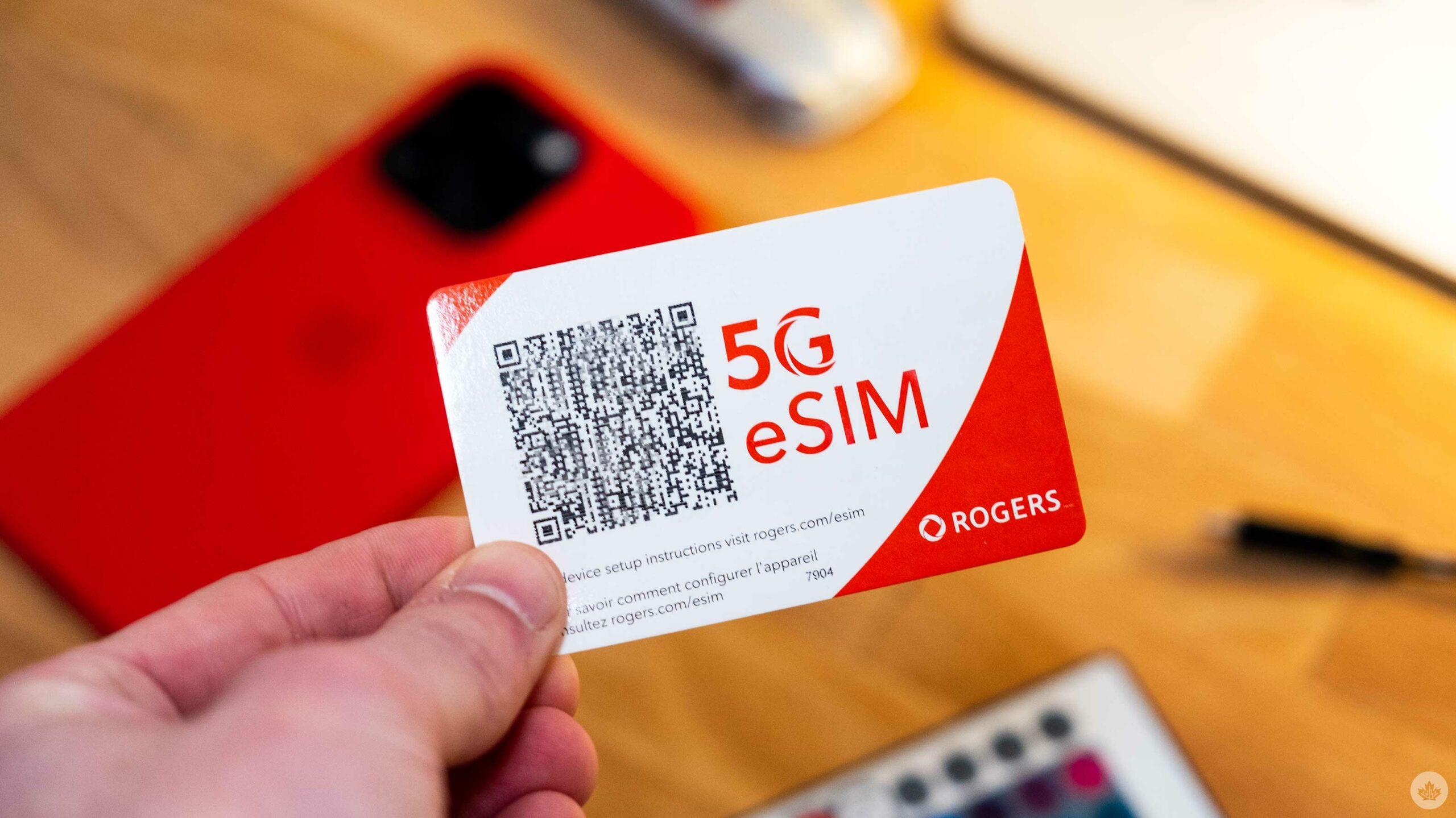 Holding a 5G eSIM card next to a smartphone
