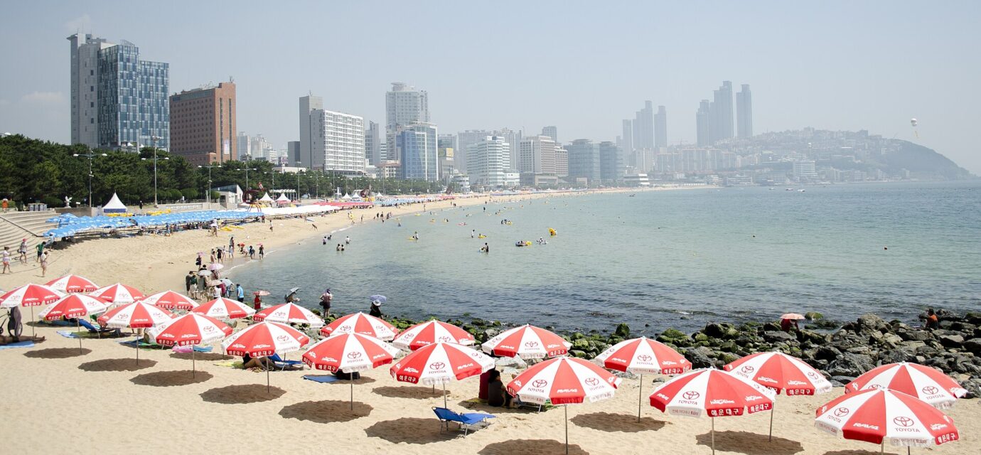 Korea summer beaches Busan Haeundae sandy shore and hotel skyline