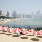 Korea summer beaches Busan Haeundae sandy shore and hotel skyline