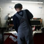 Used car inspection checklist - mechanic checking engine oil at a Korean auto repair shop