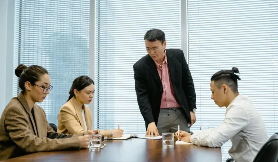 Korean workplace hierarchy shown through a manager-led team meeting