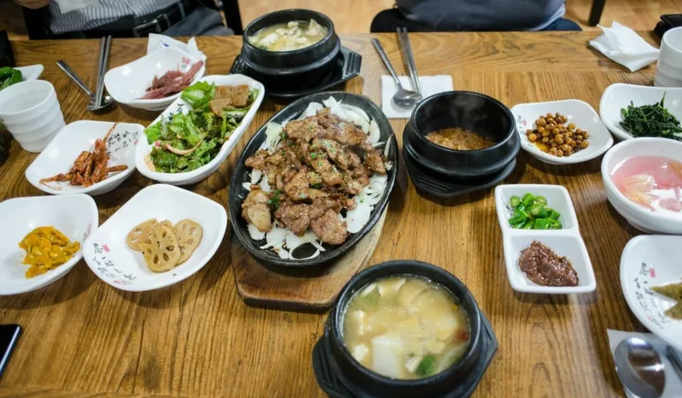Korean food basics — a complete Korean home-style table spread with kimchi, banchan, and soup