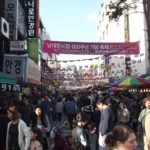 Crowded shopping alley in Namdaemun Market, Seoul